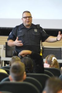 Officer Ed Ashley talking to students about Halloween safety.