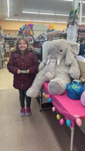 A student with Veda the stuffed elephant at Family Dollar in Nassau