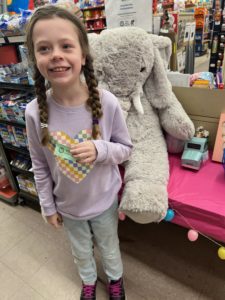 A student with Veda the stuffed elephant at Family Dollar in Nassau