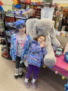 Students with Veda the stuffed elephant at Family Dollar in Nassau