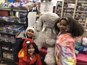 Students with Veda the stuffed elephant at Family Dollar in Nassau