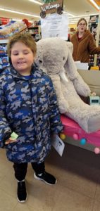A student with Veda the stuffed elephant at Family Dollar in Nassau