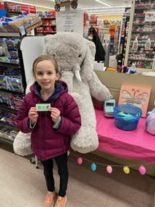 A student with Veda the stuffed elephant at Family Dollar in Nassau