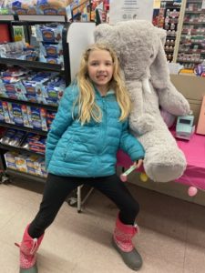 A student with Veda the stuffed elephant at Family Dollar in Nassau