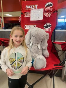 A student with Veda the stuffed elephant at Hannaford in East Greenbush