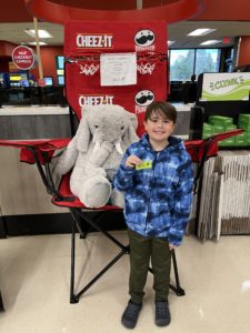 A student with Veda the stuffed elephant at Hannaford in East Greenbush