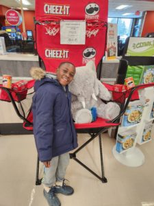 A student with Veda the stuffed elephant at Hannaford in East Greenbush