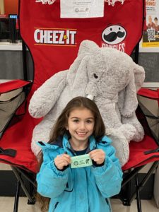A student with Veda the stuffed elephant at Hannaford in East Greenbush