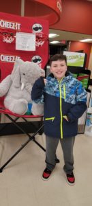 A student with Veda the stuffed elephant at Hannaford in East Greenbush