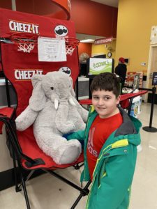 A student with Veda the stuffed elephant at Hannaford in East Greenbush