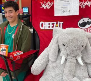 A student with Veda the stuffed elephant at Hannaford in East Greenbush