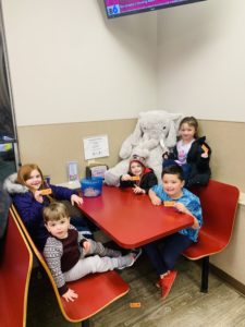Students with Veda the stuffed elephant at Stewart's in Nassau