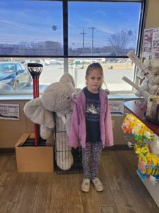 A student with Veda the stuffed elephant at Stewart's in Nassau