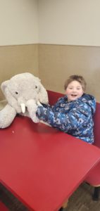 A student with Veda the stuffed elephant at Stewart's in Nassau