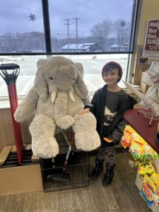 A student with Veda the stuffed elephant at Stewart's in Nassau