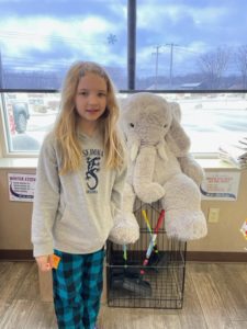 A student with Veda the stuffed elephant at Stewart's in Nassau