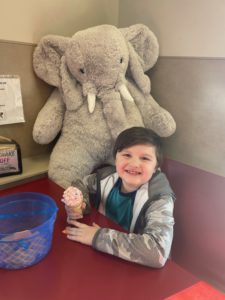 A student with Veda the stuffed elephant at Stewart's in Nassau