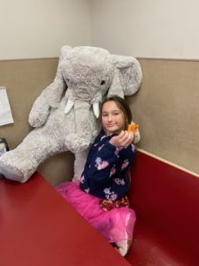 A student with Veda the stuffed elephant at Stewart's in Nassau