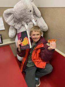 A student with Veda the stuffed elephant at Stewart's in Nassau