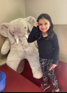 A student with Veda the stuffed elephant at Stewart's in Nassau
