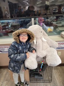A student with Veda the stuffed elephant at Stewart's in Nassau