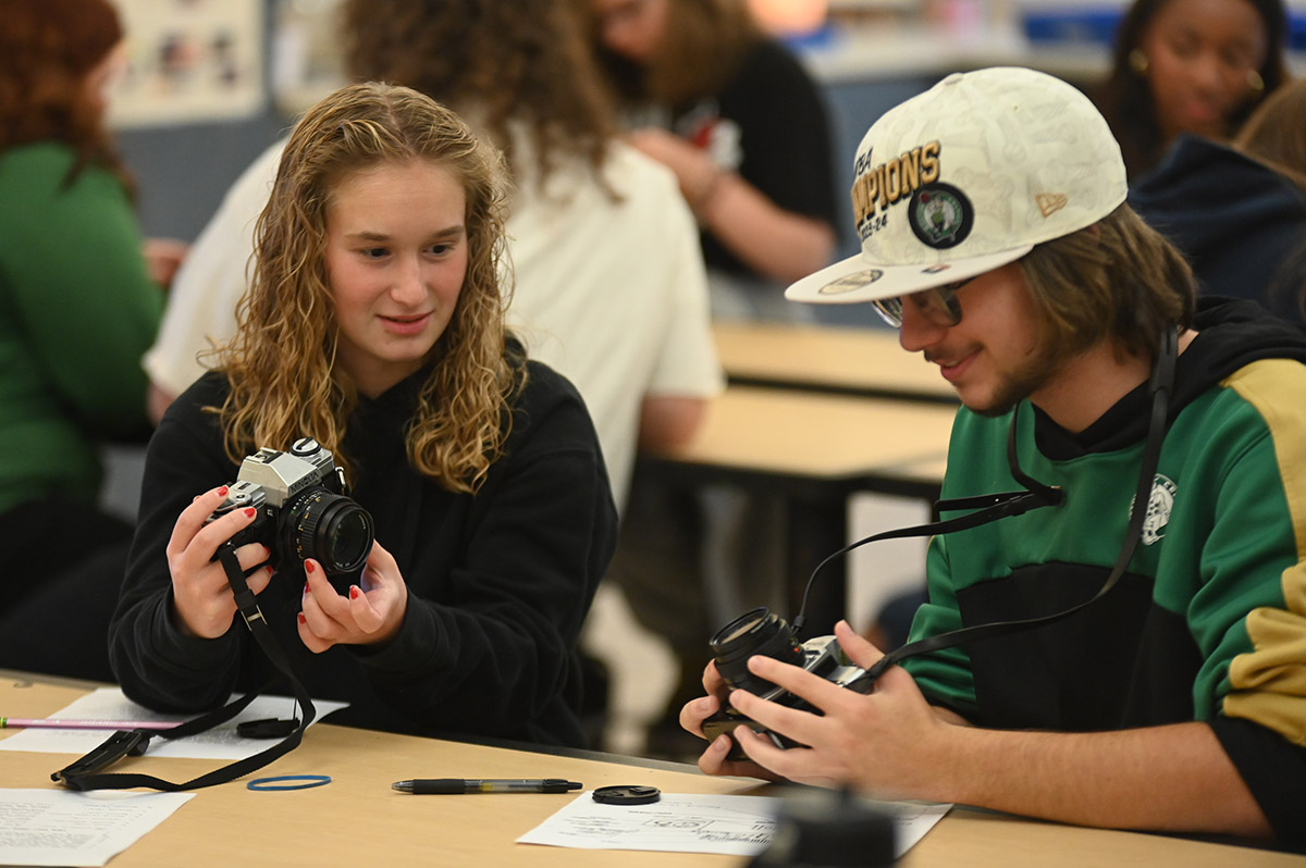 Students in Ms. Neiman's photography class learning about single lens reflex (SLR) cameras.