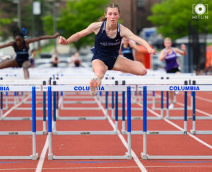 Ava Weiss running hurdles at a track meet (courtesy Hitlin Photography)